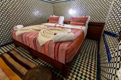a bedroom with a bed in a room with at Dar Attajalli in Fès