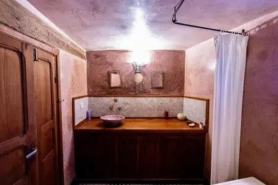 a bathroom with a sink and a shower curtain at Dar Attajalli in Fès