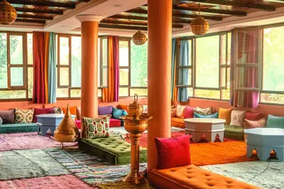 a living room with colorful furniture and windows at ferme by Ikalimo in Ourika