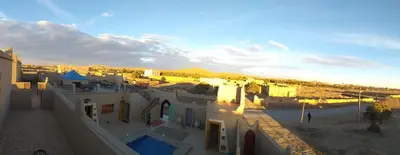 an aerial view of a city with a building at Hassilabiad Appart Hotel in Merzouga