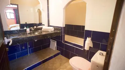 a bathroom with a sink and a toilet at Hotel Kasbah Asmaa in Midelt