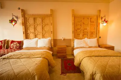 a hotel room with two beds in a room at Hotel Kasbah Asmaa in Midelt