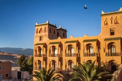 a large yellow building with a clock tower at Hotel Kasbah Asmaa in Midelt