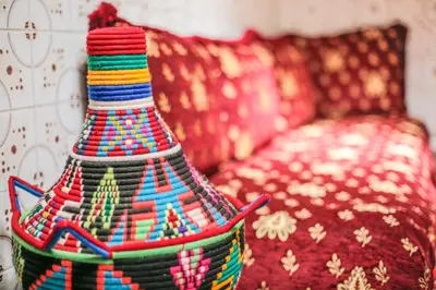 a colorful vase sitting next to a couch at Dar Widad in Ouarzazate