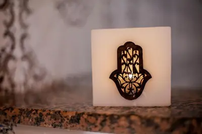 a black and white candle with a butterfly cookie on it at Dar Widad in Ouarzazate