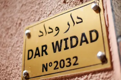 a sign on a wall that reads car withdrawal at Dar Widad in Ouarzazate