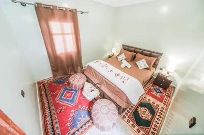 a small bedroom with a bed and a window at Dar Widad in Ouarzazate