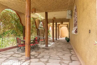 an outdoor patio with a table and chairs on it at Riad Zagora Palms in Zagora