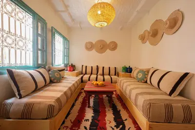 a living room with two couches and a table at Dar Soufian in Ouarzazate