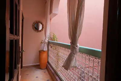 a balcony with a curtain and a vase at Dar Soufian in Ouarzazate