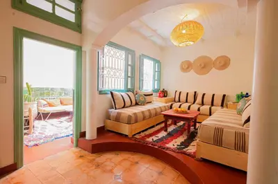 a living room with a couch and a table at Dar Soufian in Ouarzazate