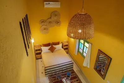 a small bedroom with a bed and a window at Dar Soufian in Ouarzazate