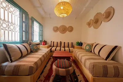 a living room with two couches and a table at Dar Soufian in Ouarzazate