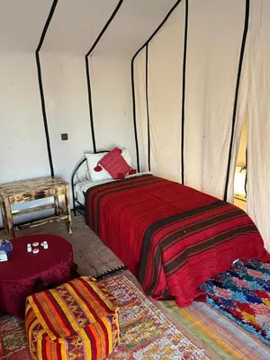 a bedroom with two beds in a tent at Bivouac Luna in Mhamid