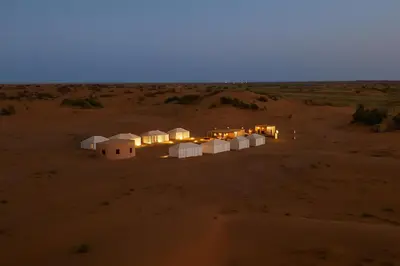 an aerial view of a camp in the desert at night at Bivouac Luna in Mhamid