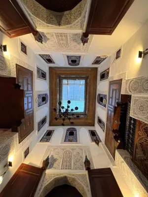 a large room with a ceiling with a window at Dar Lalla Kenza in Fès