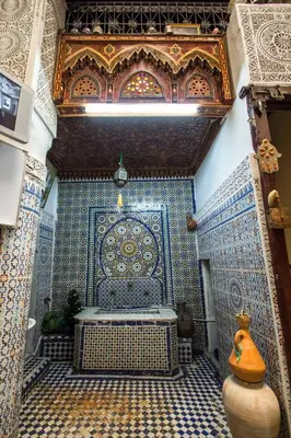 a tiled room with a bench in a building at Dar Lalla Kenza in Fès