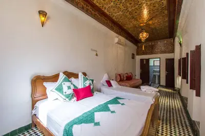 a bedroom with two beds in a room at Dar Lalla Kenza in Fès