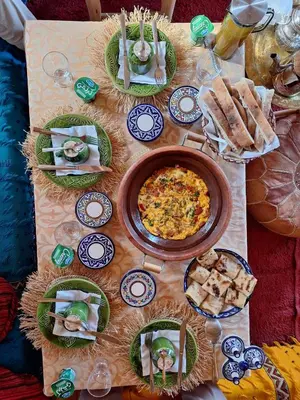 a table with plates of food on top at Authentique berber Camp & Activities in Mhamid