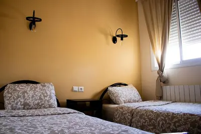 a bedroom with two beds and a window at Un havre de paix à Ifrane in Ifrane