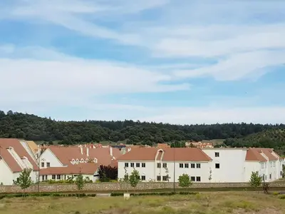 a row of white buildings with brown roofs at Un havre de paix à Ifrane in Ifrane
