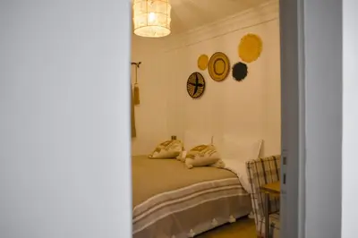 a bedroom with a bed with two pillows on it at Hotel Riad Amlal in Ouarzazate