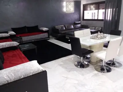 a living room with a couch and a table at top Appartement in Fes City Marbella House in Fès