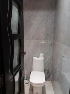 a bathroom with a white toilet in a room at top Appartement in Fes City Marbella House in Fès