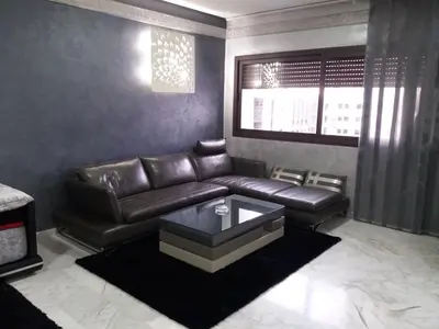 a living room with a leather couch and a table at top Appartement in Fes City Marbella House in Fès