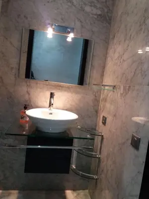 a bathroom with a sink and a mirror at top Appartement in Fes City Marbella House in Fès