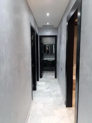 a hallway leading to a bathroom with a sink at top Appartement in Fes City Marbella House in Fès