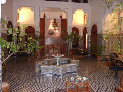 a room with tables and chairs in a building at Dar Al Safadi in Fès