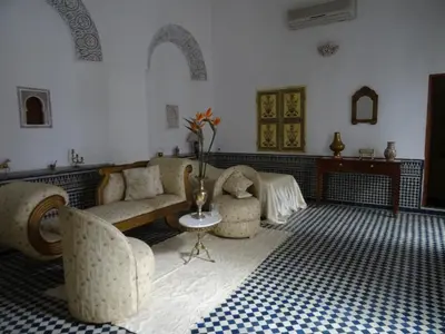 a living room with a couch and chairs and a table at Dar Al Safadi in Fès