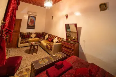 a living room with a couch and a table at Dar Lalla Bouchra in Fès