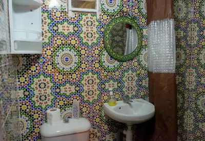 a bathroom with a sink and a mirror at Dar Lalla Bouchra in Fès