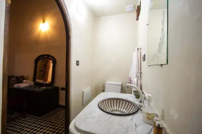 a bathroom with a sink and a mirror at Dar Alami Salaj in Fès