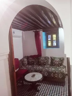 a living room with a couch and a table at Dar Alami Salaj in Fès