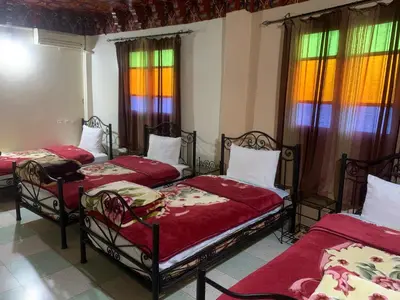 three beds in a room with stained glass windows at Bab Al Madina in Fès