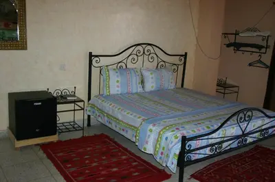 a bedroom with a bed and a tv at Bab Al Madina in Fès