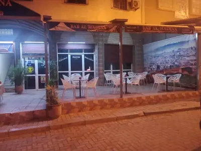 a restaurant with tables and chairs in front of a building at Bab Al Madina in Fès