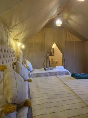 a bedroom with two beds in a tent at Sahara Bedouins Camp in Hassilabied