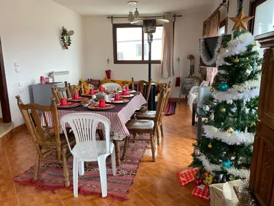 a dining room with a table and a christmas tree at Villa SALAM in Ifrane