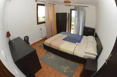 a small bedroom with a bed and a window at Villa SALAM in Ifrane