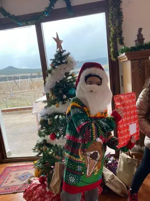 a santa claus standing next to a christmas tree at Villa SALAM in Ifrane