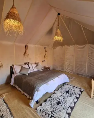 a bedroom with a bed in a tent at Blue Sky Luxury Camp in Merzouga