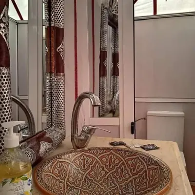 a bathroom with a sink and a mirror at Blue Sky Luxury Camp in Merzouga