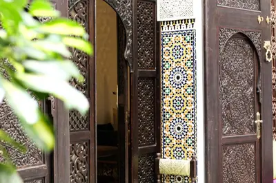an open wooden door with a window on it at Le Grand Alcazar - Riad in Fès