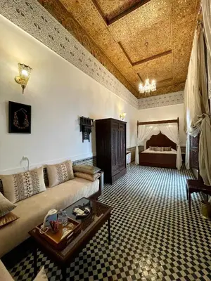 a living room with a couch and a table at Le Grand Alcazar - Riad in Fès