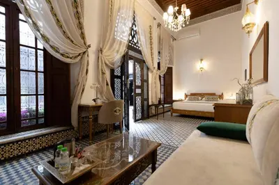 a living room with a couch and a bed at Le Grand Alcazar - Riad in Fès