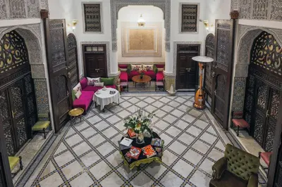 an overhead view of a living room with pink furniture at Le Grand Alcazar - Riad in Fès